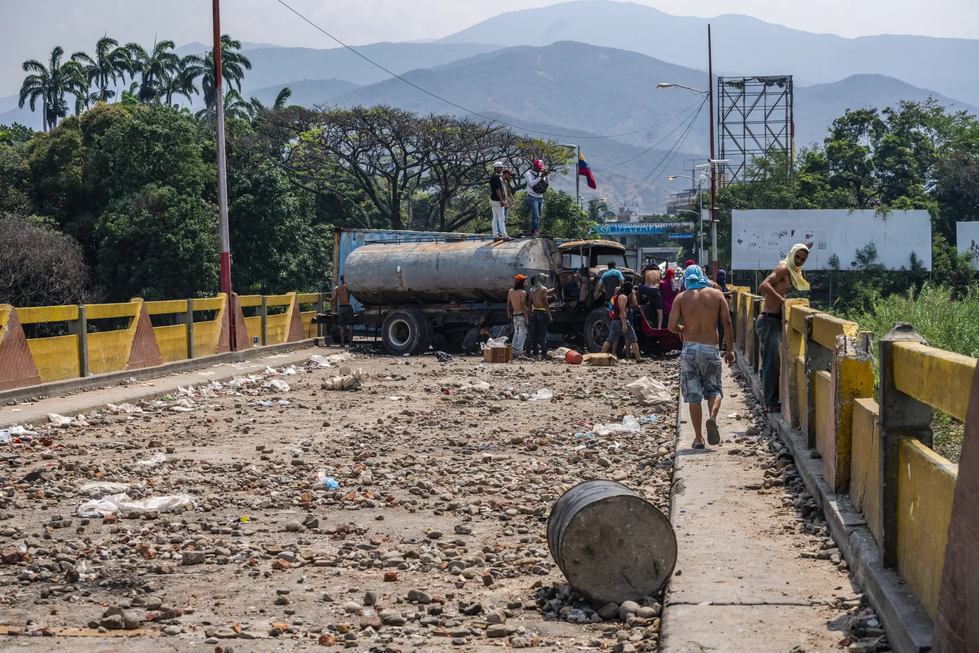People gather near a destroyed truck near the border with Venezuela in Cucuta, Colombia on Feb. 24.