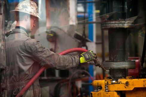 Rig hands thread together drilling pipe at a hydraulic fracturing site located atop the Marcellus shale rock formation in Washington Township, Pa. on Oct. 31, 2013.