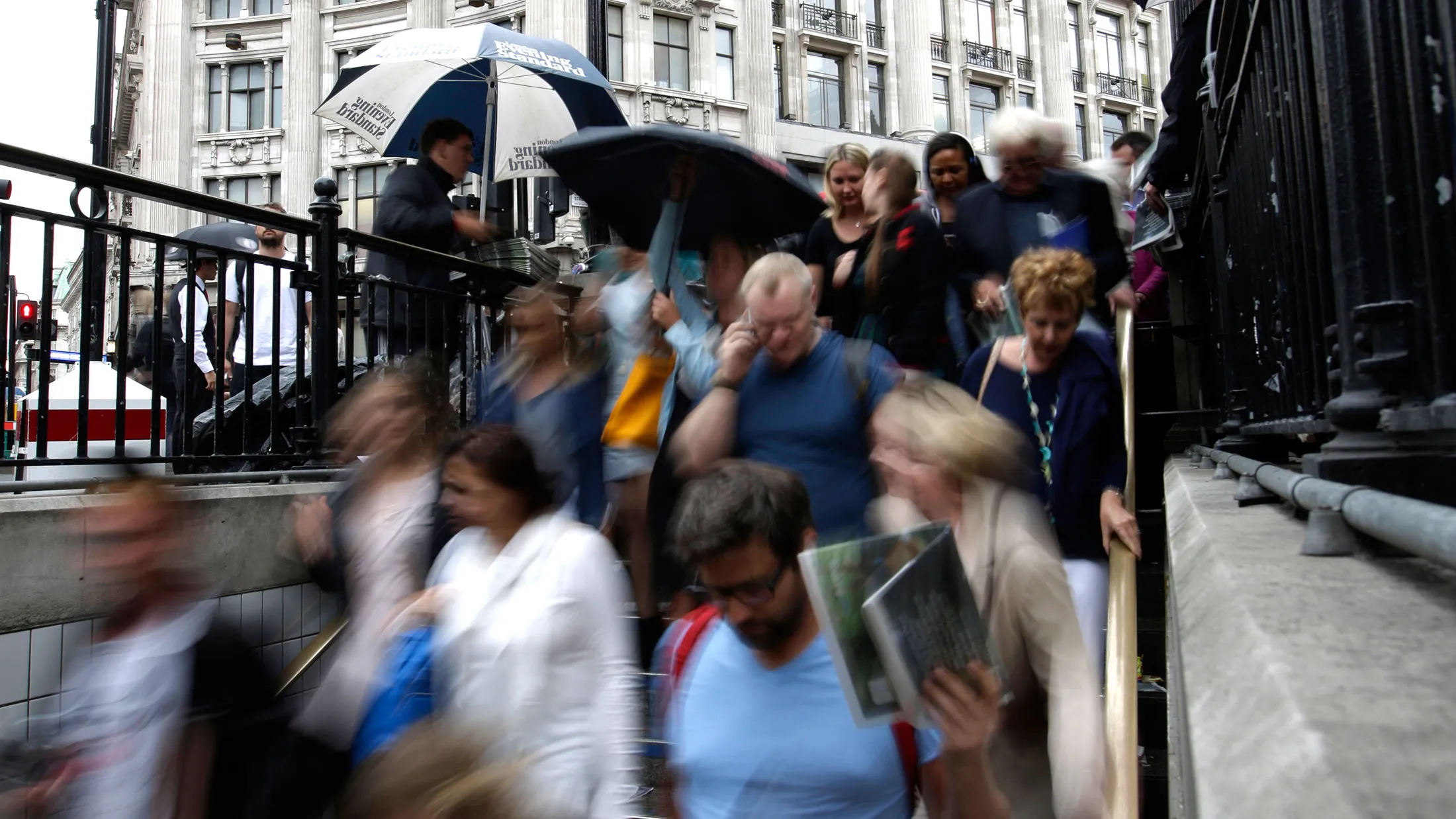 Commuters enter Oxford Circus tube station in London, U.K.
