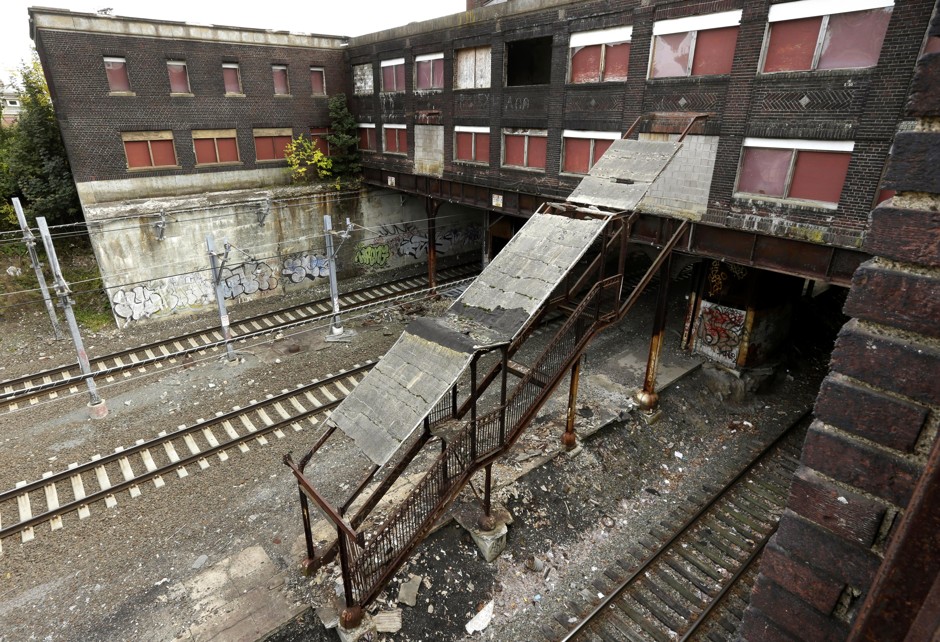 A dilapidated stairway leads from railroad tracks to a sealed entrance of the abandoned Pawtucket-Central Falls train station, in Central Falls, R.I. 