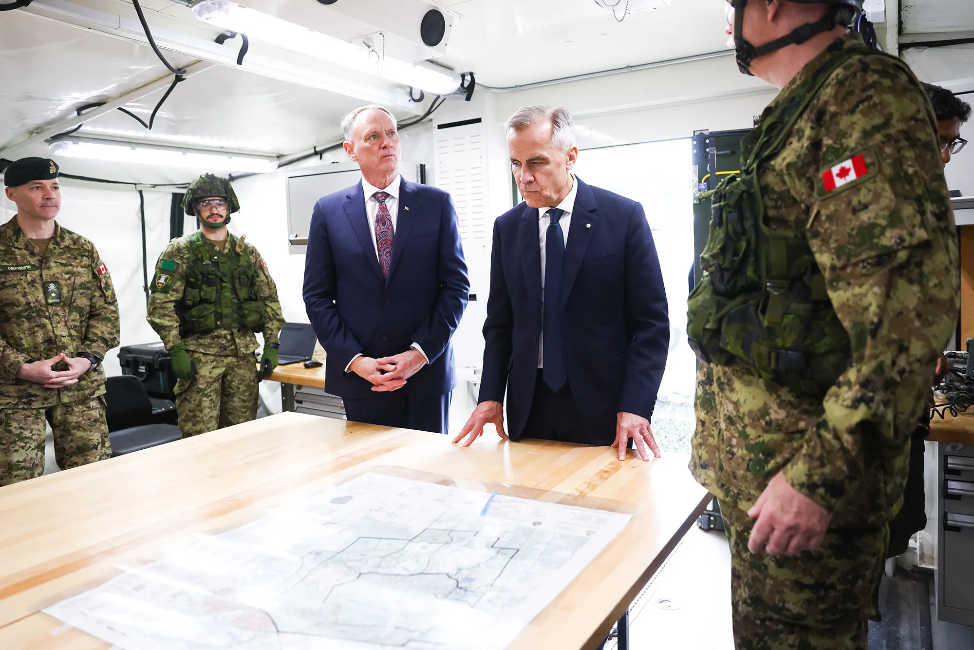 Canadian Prime Minister Mark Carney and Minister of National Defence David McGuinty meet with Canadian troops in Toronto on June 9.