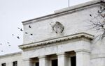 Birds fly past the Marriner S. Eccles Federal Reserve Board building in Washington, D.C., U.S.