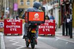 A food delivery courier for Just Eat Takeaway.com NV along Brick Lane in London.