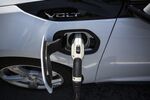 A ClipperCreek Inc. charging plug is seen connected to a General Motors Chevrolet Volt electric vehicle .