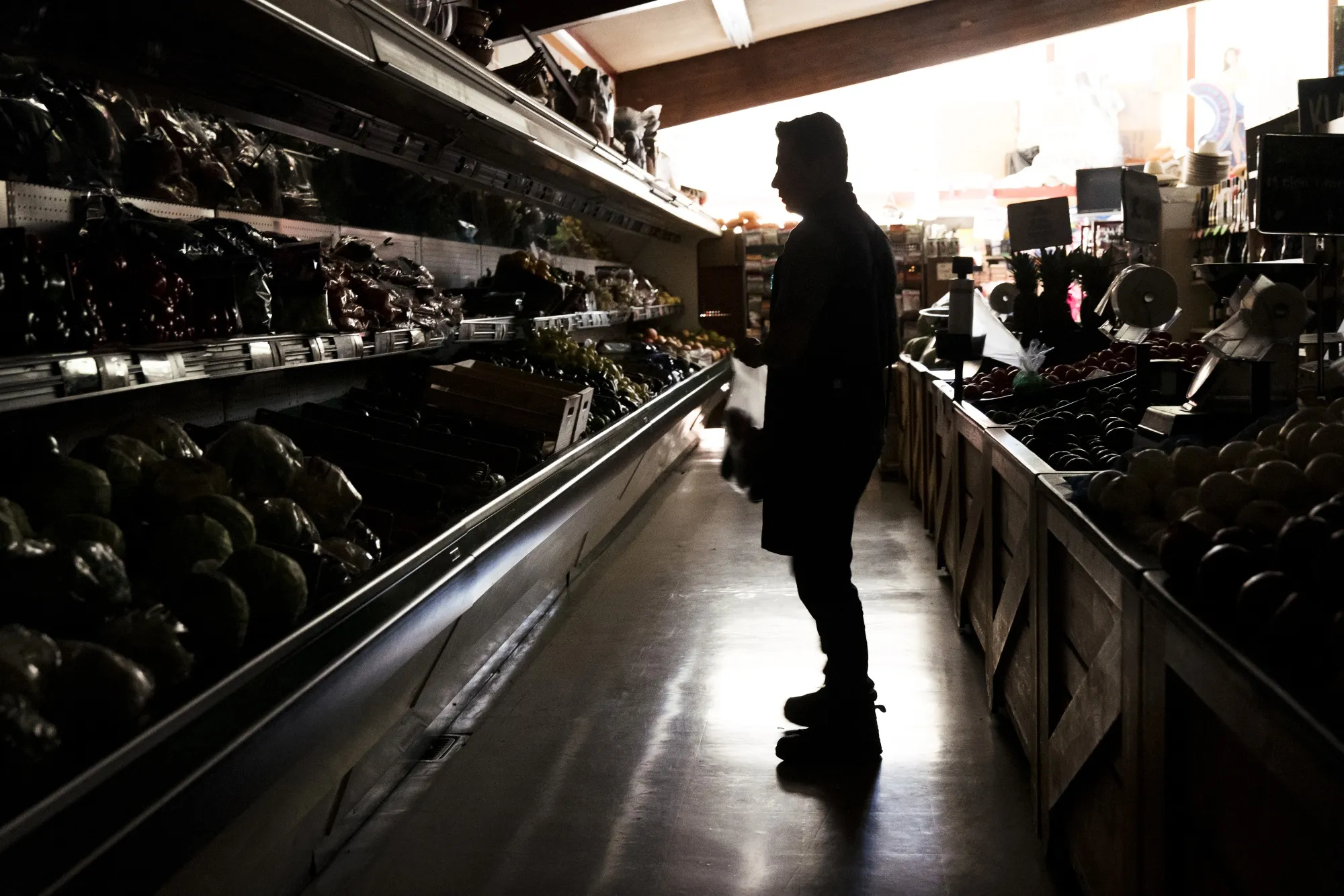 A customer shops for groceries at La Tapatia Market during a blackout in Napa, California, U.S., on Oct. 9.