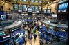 Traders work on the floor of the New York Stock Exchange (NYSE) in New York, U.S., on Wednesday, Dec. 21, 2016. U.S. stocks fluctuated with the Dow Jones industrial Average failing to make progress toward 20,000 as oil erased gains and a rally in the dollar faltered in light trading ahead of the holidays.
