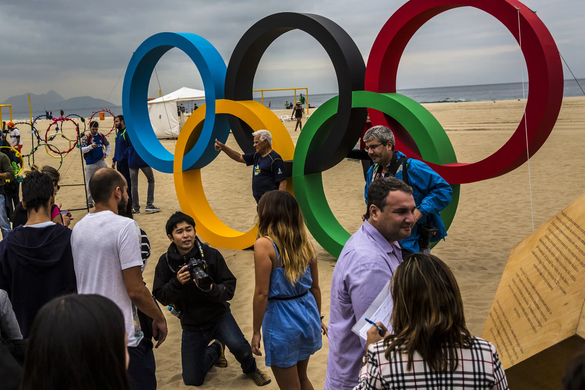 Visitors take photographs of the newly unveiled Olympic Rings on Copacabana beach in Rio de Janeiro, Brazil, on July 21, 2016.

