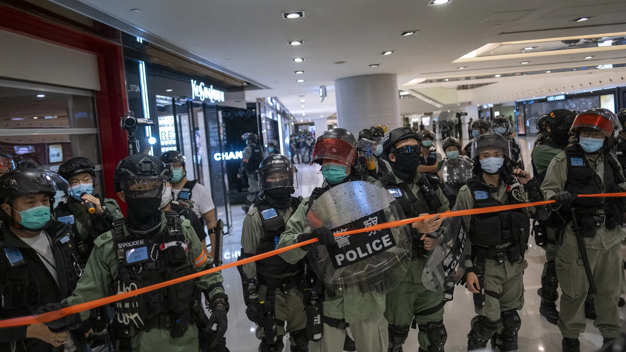 Riot police wearing protective masks attempt to disperse a crowd during a protest in Hong Kong on May 1.