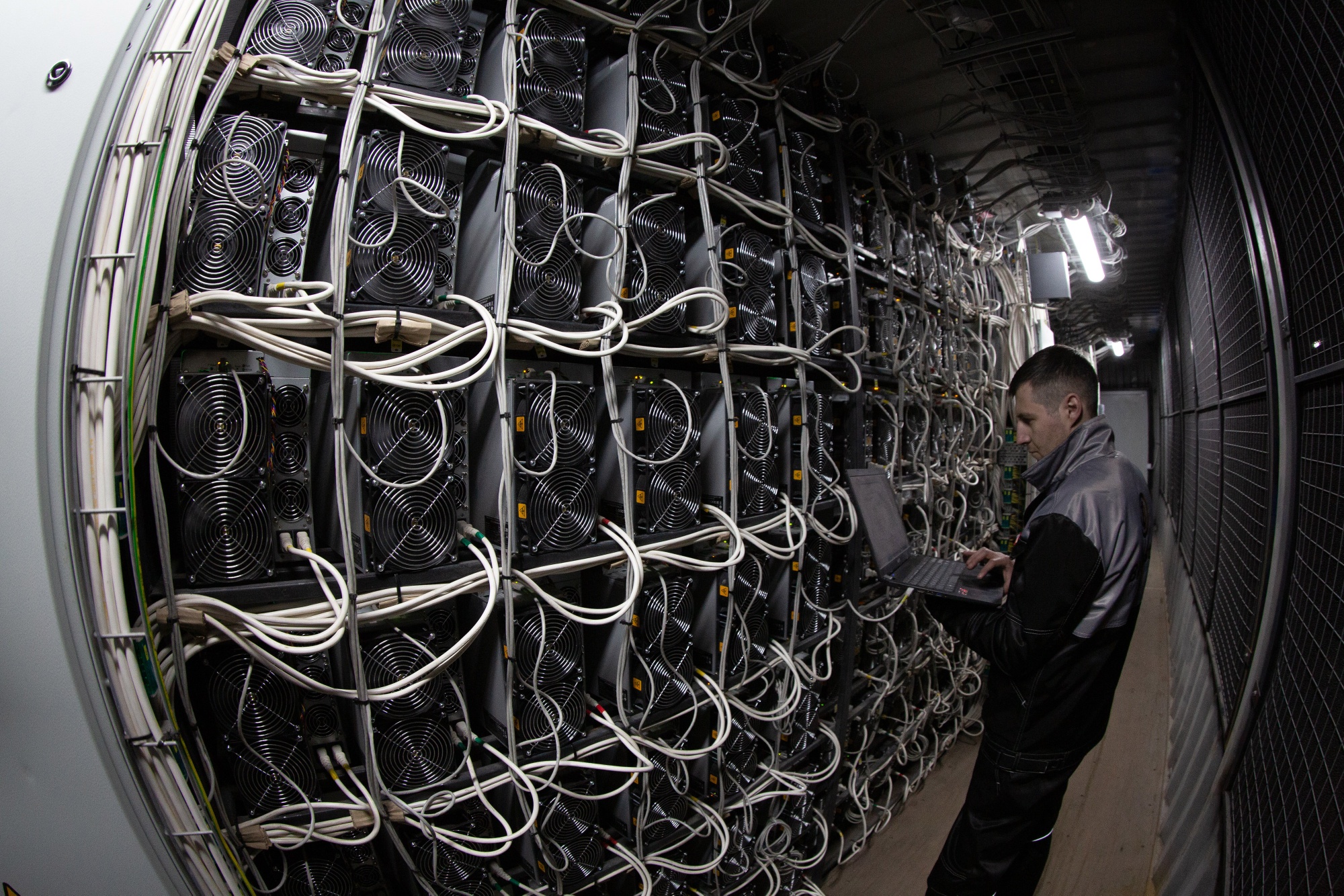 An engineer runs diagnostic tests at a cryptocurrency mining farm in Norilsk, Russia.