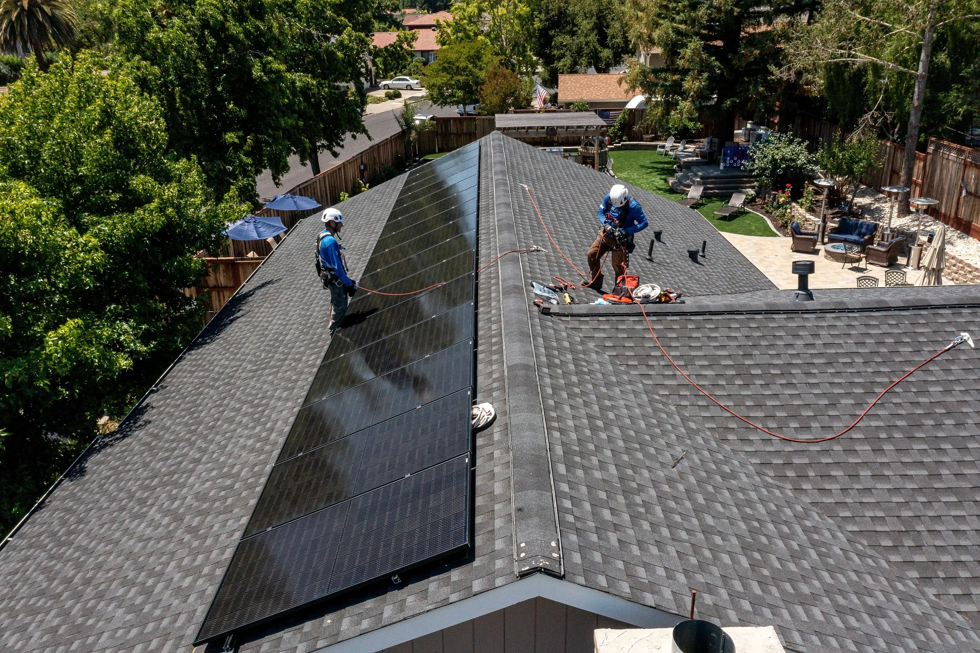 Workers install solar panels on a home in Napa, California.