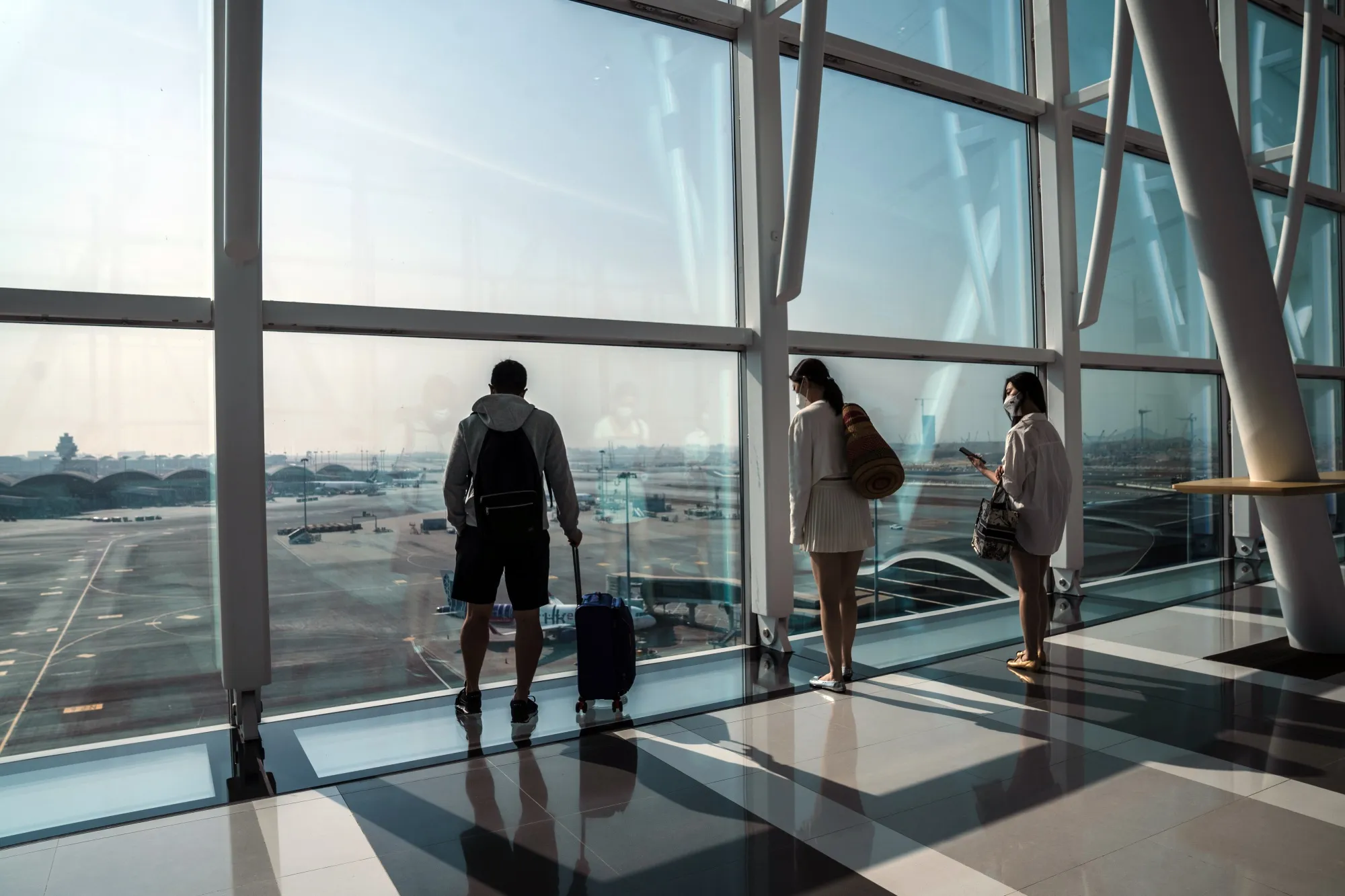 Travelers on the skybridge at Hong Kong International Airport.