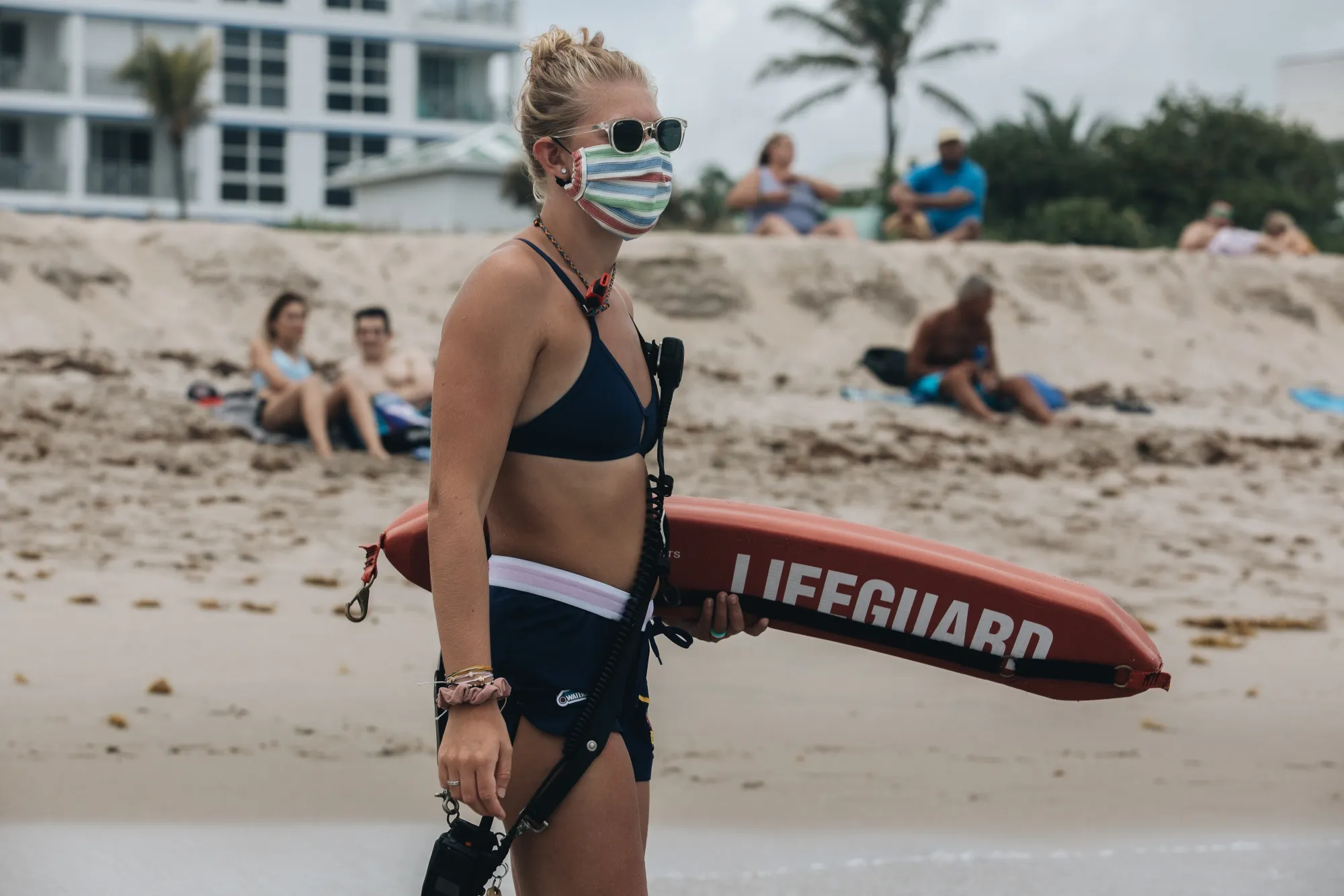 A lifeguard wearing a protective mask stands guard of the current at the beach in Delray Beach, Florida.