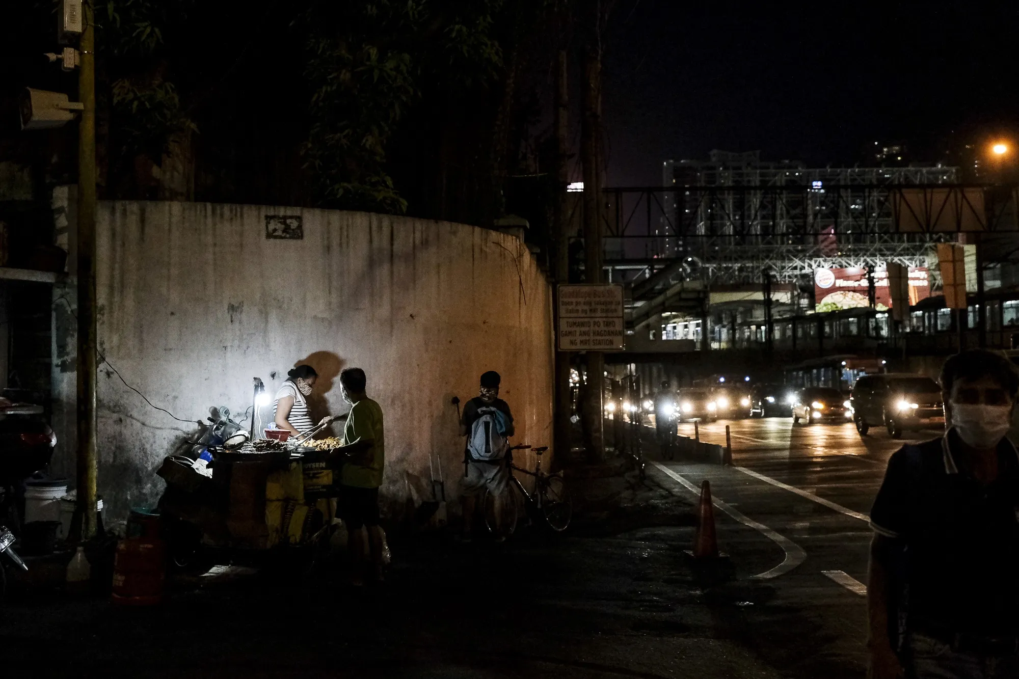 A street vendor sells food along the Epifanio de los Santos Avenue&nbsp;highway in Metro Manila, the Philippines.