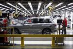 Workers perform final inspections on a vehicle at the Nissan Motor Co. manufacturing facility in Smyrna, Tennessee, U.S.