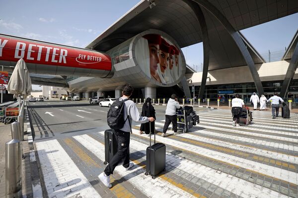 Travelers arrive at Dubai International Airport.