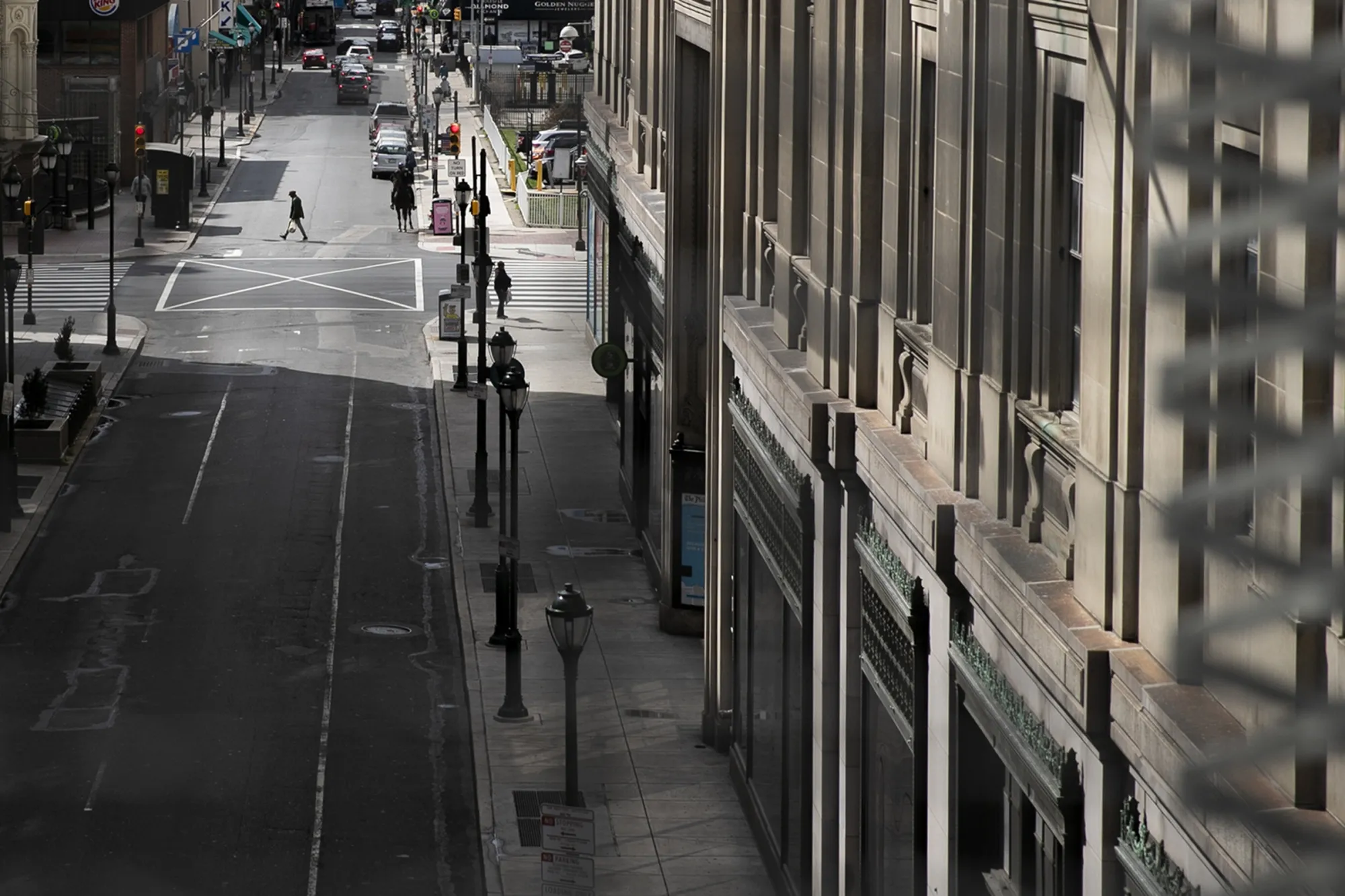 A lone pedestrian crosses at 8th and Market streets in Philadelphia, Penn. on March 24.