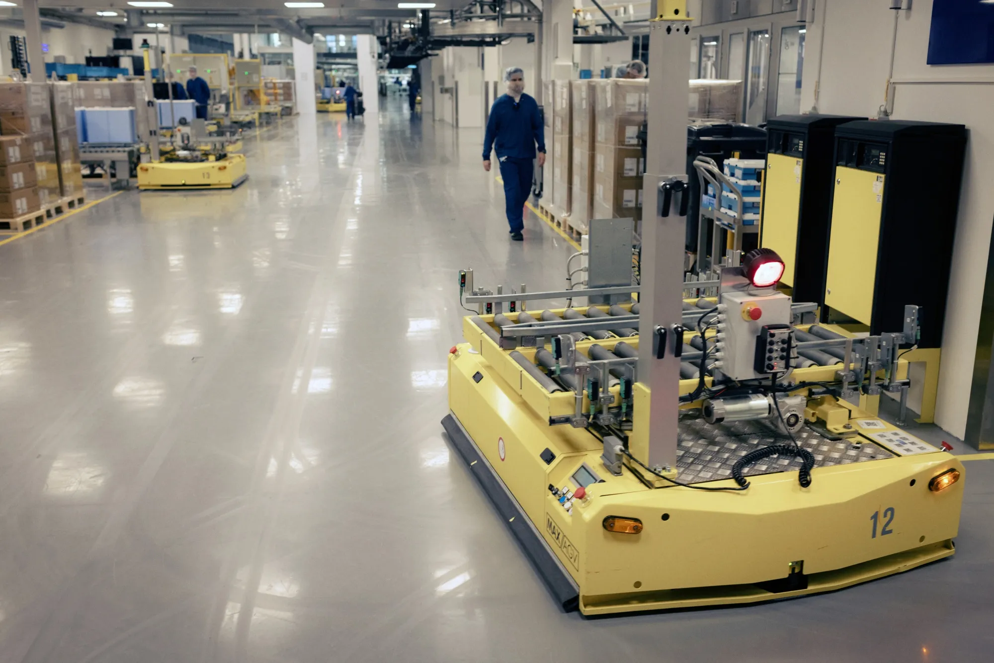 Robots move crates of finished products at the Novo Nordisk A/S production facilities in Hillerod, Denmark.