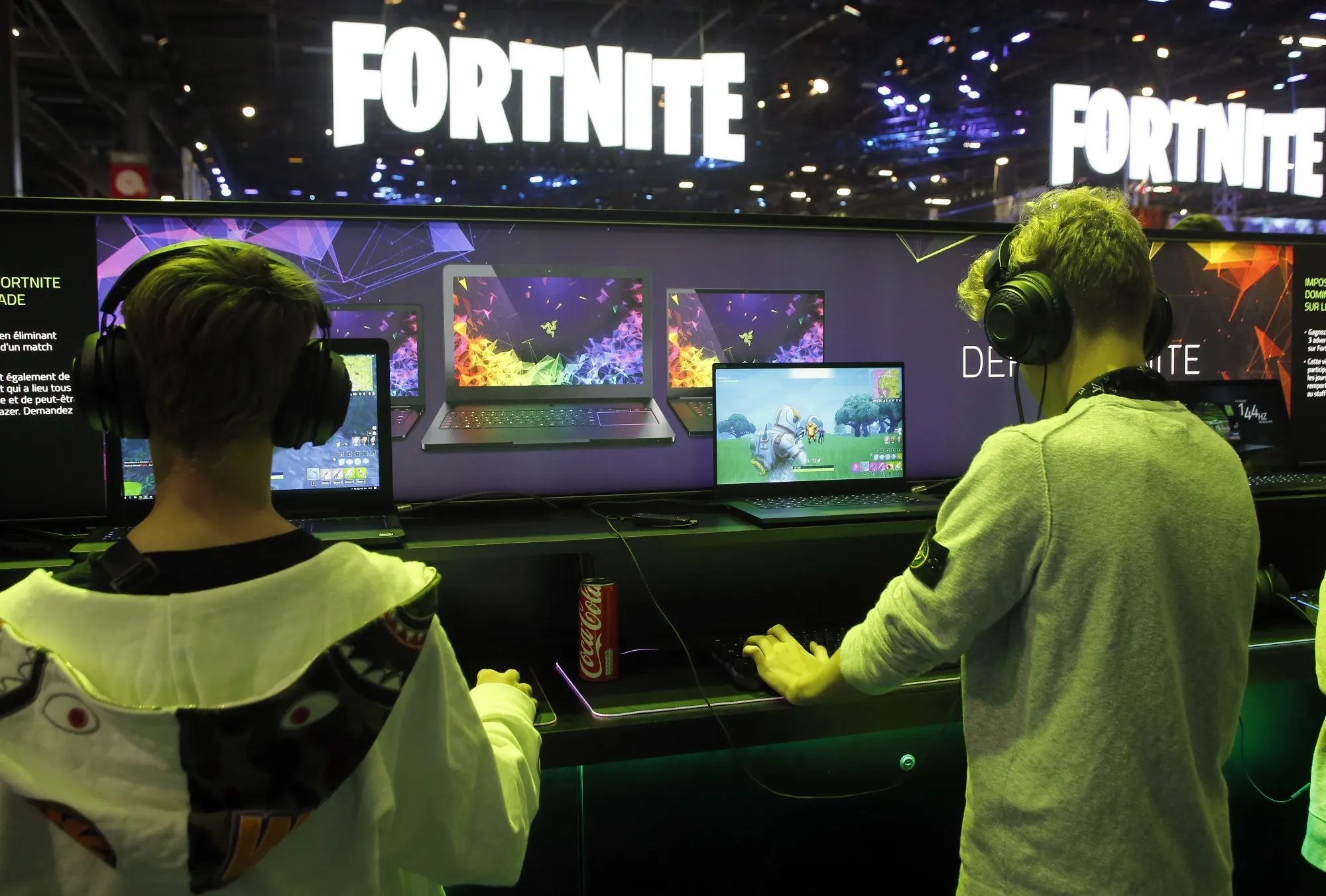 PARIS, FRANCE - OCTOBER 25:  Gamers play the video game 'fortnite' developed by Epic Games on a laptop from the Razer company during the 'Paris Games Week' on October 25, 2018 in Paris, France. 'Paris Games Week' is an international trade fair for video games and runs from October 26 to 31, 2018.  (Photo by Chesnot/Getty Images)