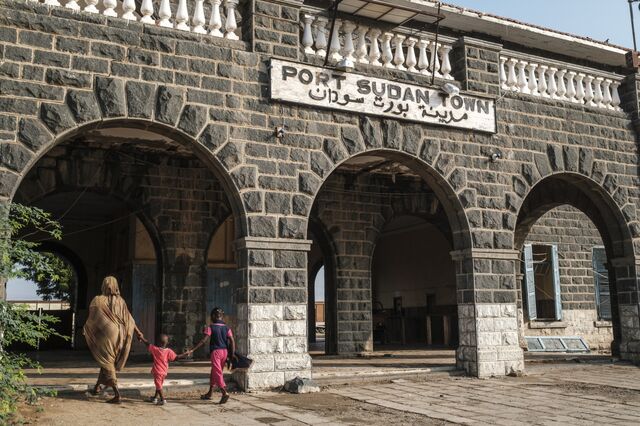 A woman and children enter the train station in Port Sudan. Sudan has the second longest railway lines in Africa, but it partially stopped working after the eruption of the war.