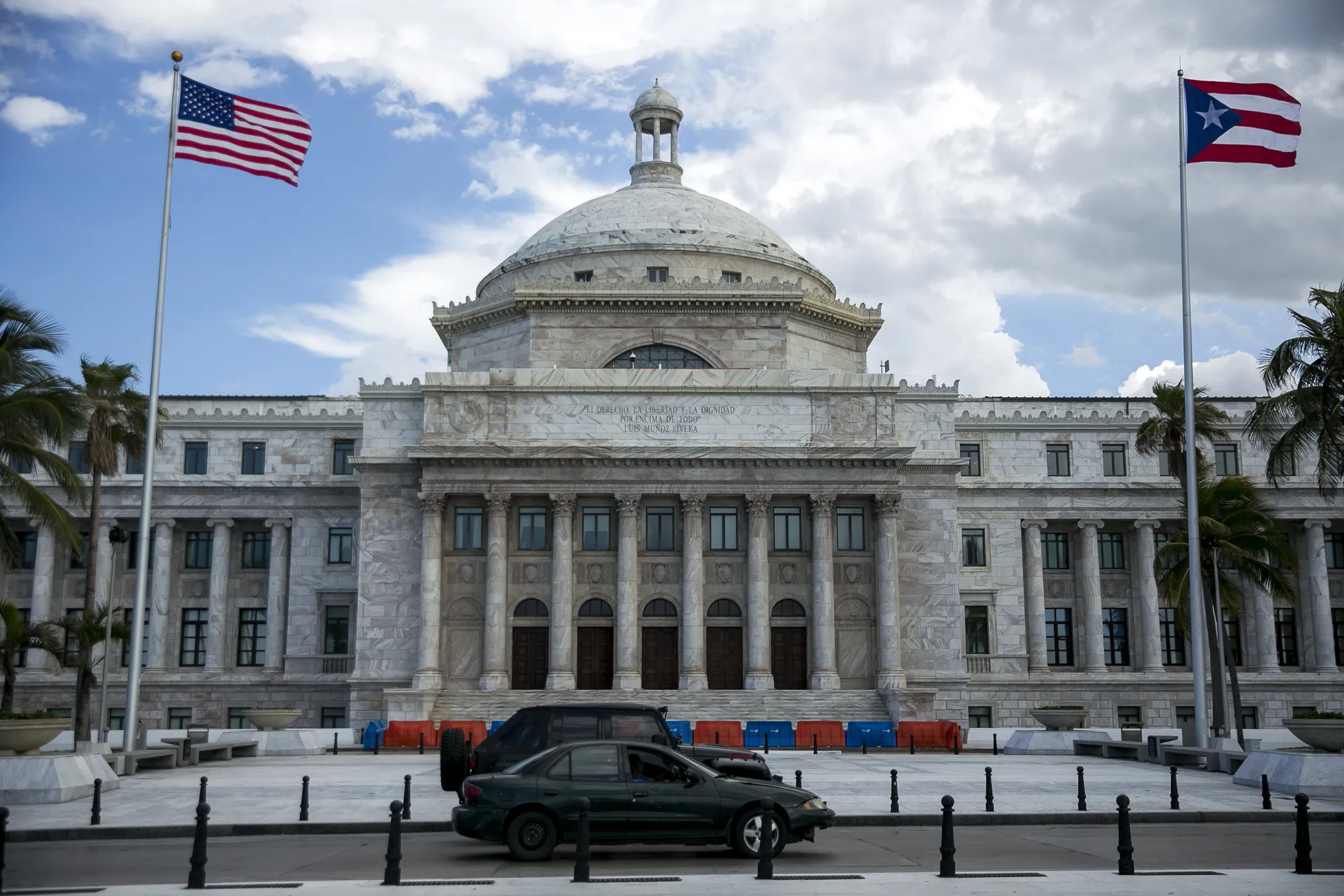 American and Puerto Rican flags fly outside the Capitol of Puerto Rico building in San Juan, Puerto Rico.