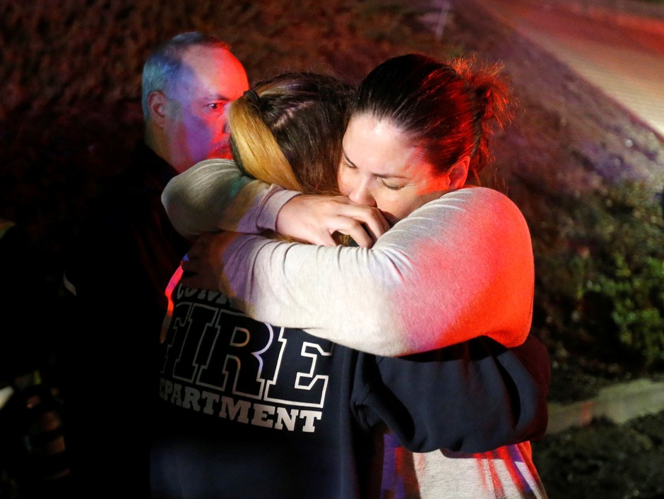 People comfort each other after a mass shooting at a bar in Thousand Oaks, California.