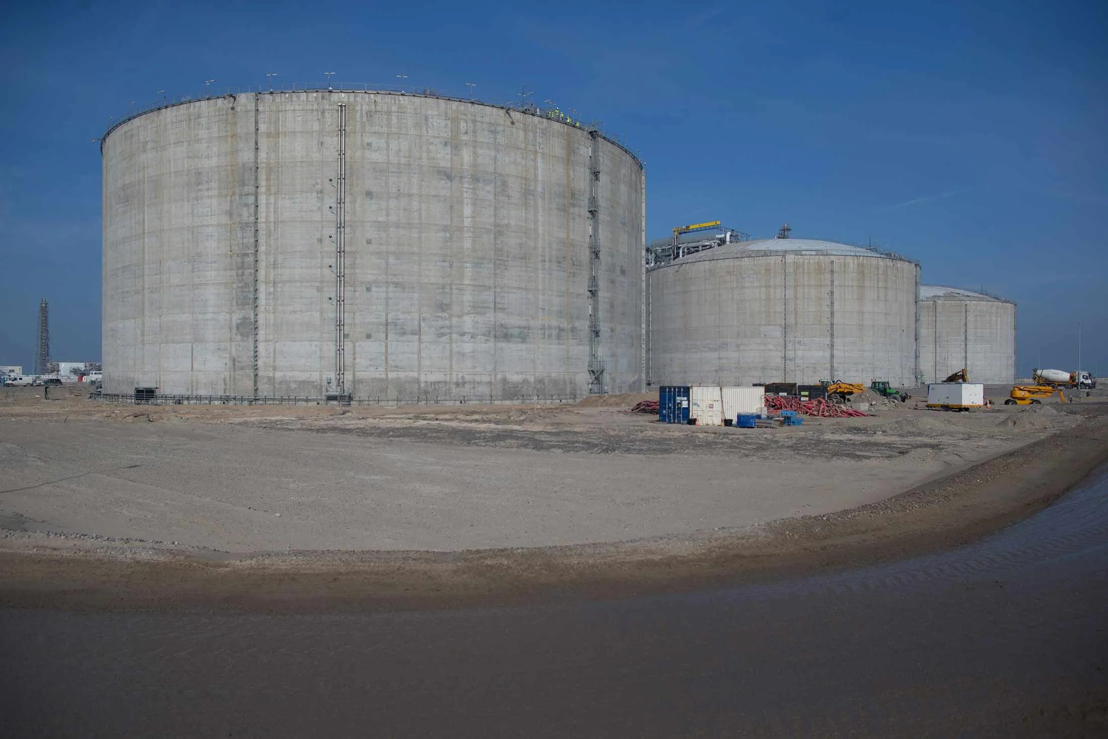 Storage silos stand as construction work continues at the liquid natural gas (LNG) terminal, a unit of Electricite de France (EDF) SA, in Dunkirk, France, on Tuesday, March 15, 2016.
