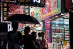 Shoppers wait in line to enter the Lung Shing Dispensary, also known as the Dragon City Pharmacy, in the Tsim Sha Tsui district of Hong Kong, China, on Tuesday, Oct. 6, 2015.
