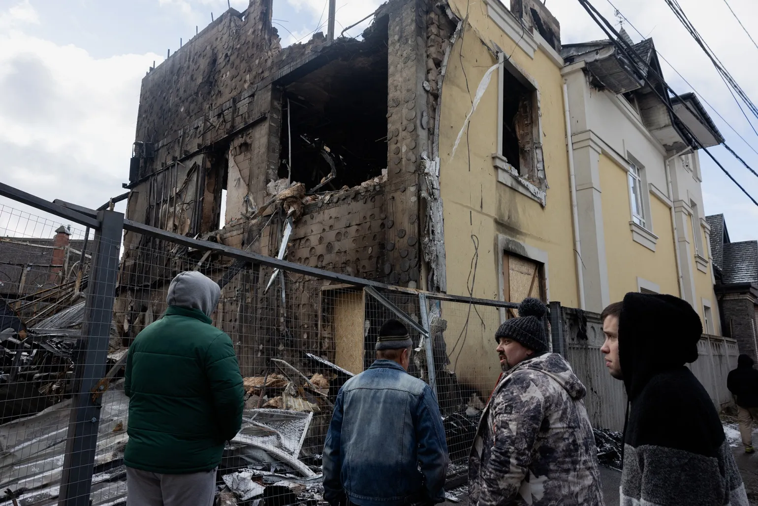 Members of the public look at a damaged house following a Russian drone&nbsp;and missile&nbsp;attack, in Kyiv, on Dec. 28.