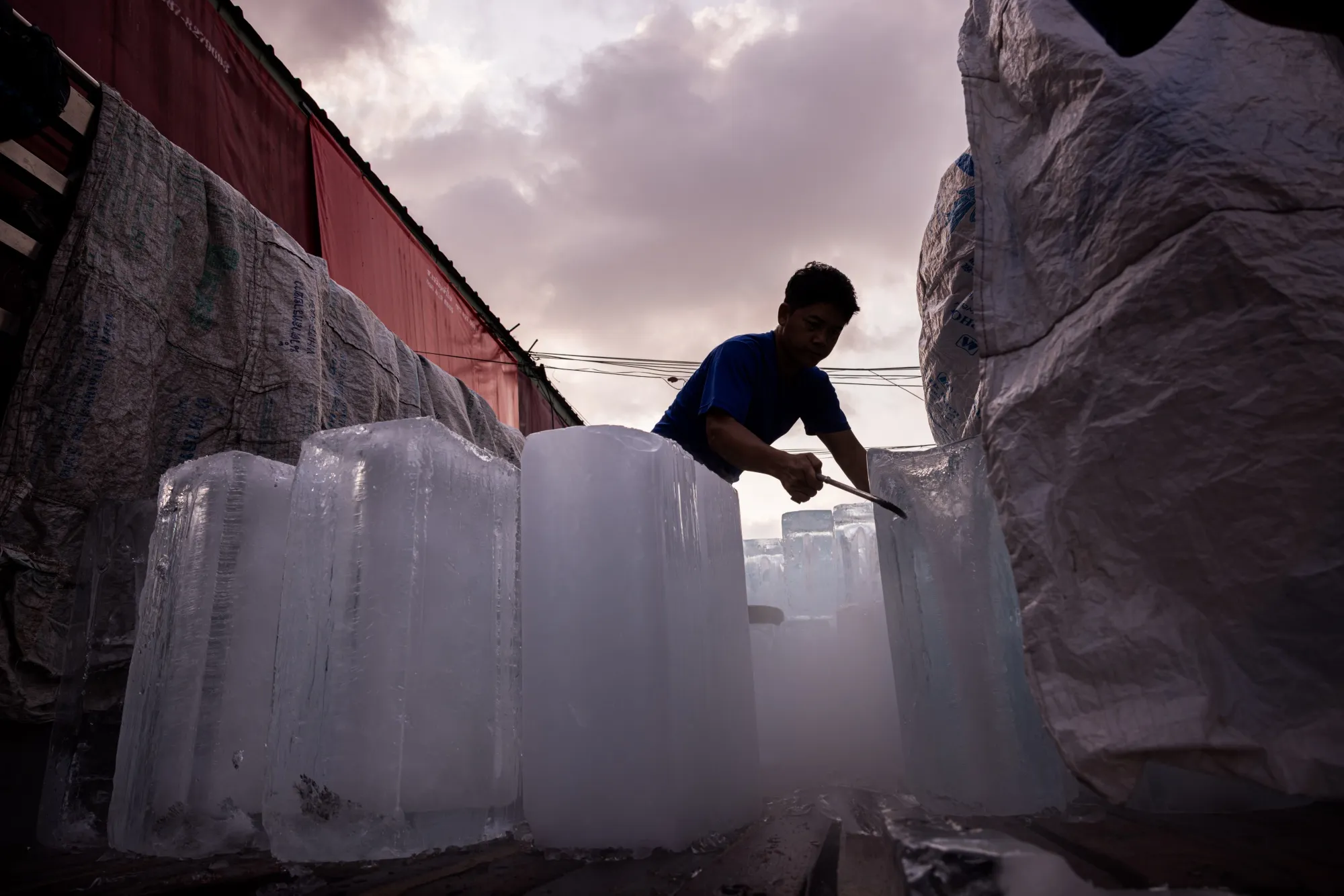 A man unloads blocks of ice from a truck during high temperatures in Bangkok on April 28.