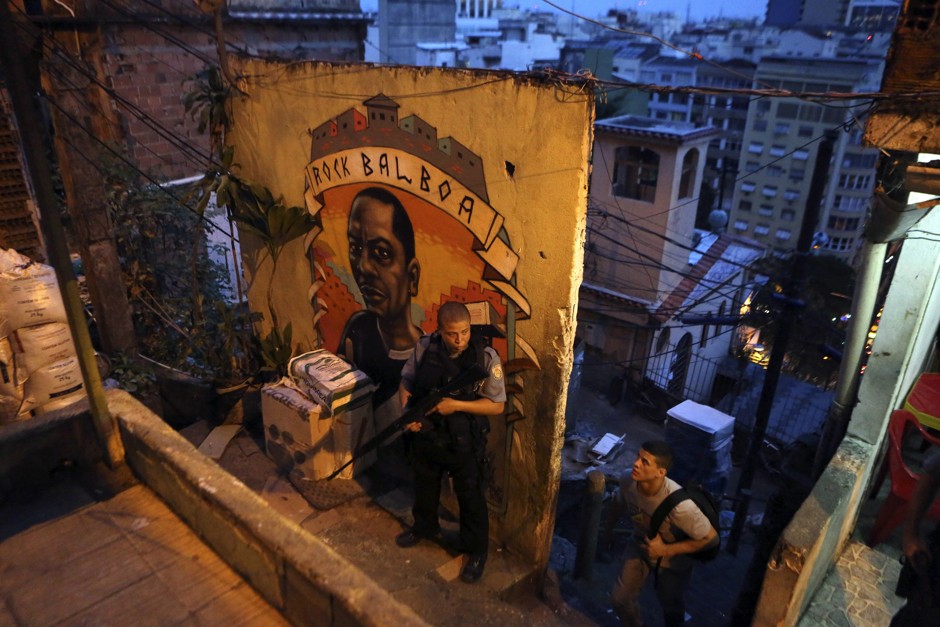 A police officer patrols the streets of the Cantagalo slum in Rio de Janeiro March 13, 2014. 