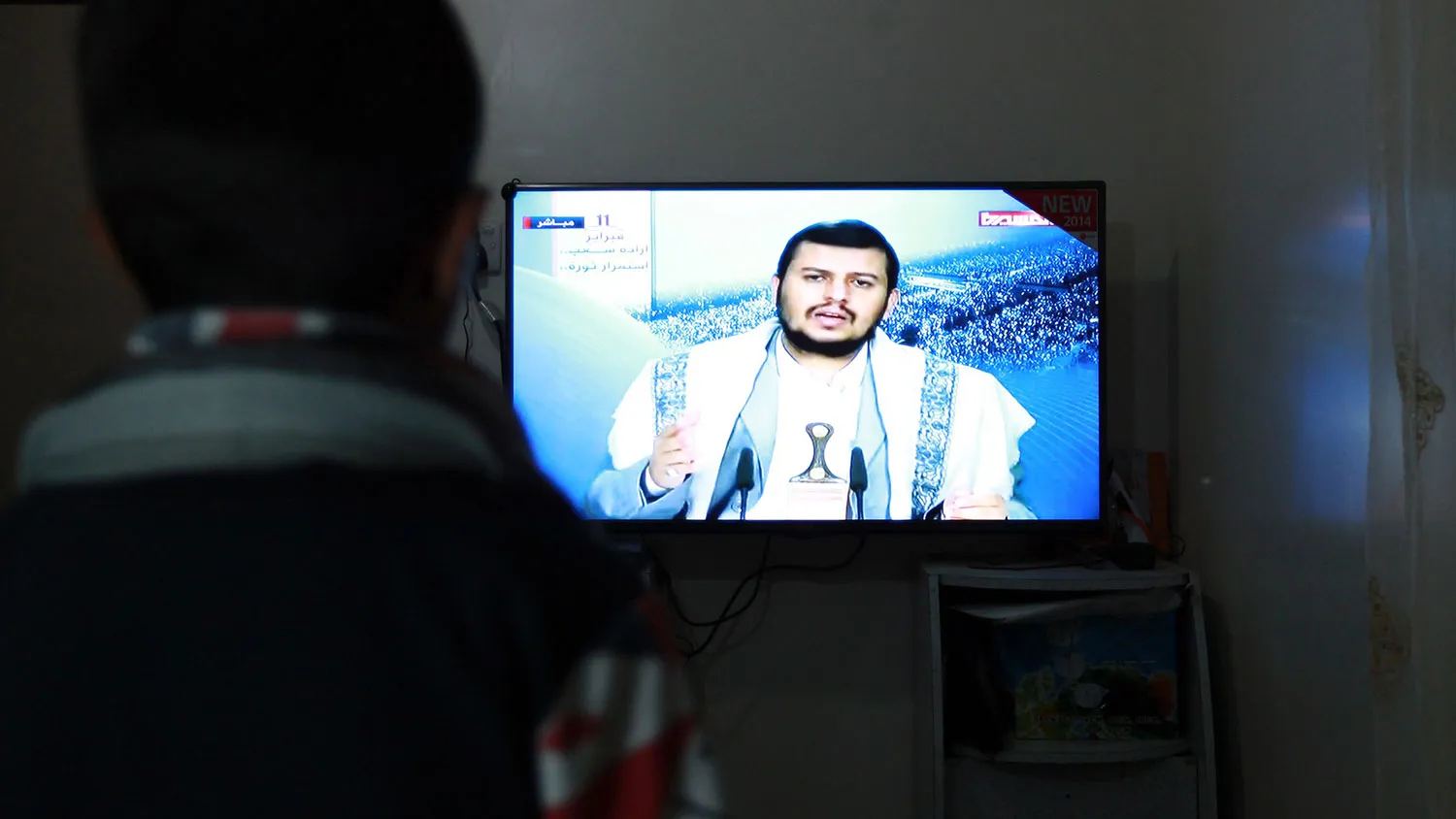 A Yemeni man watches the televised speech of the Shiite Huthi movement's leader Abdul-Malik al-Huthi in the capital Sanaa, after the US ordered the closure of its embassy in the country, on February 10, 2015.

