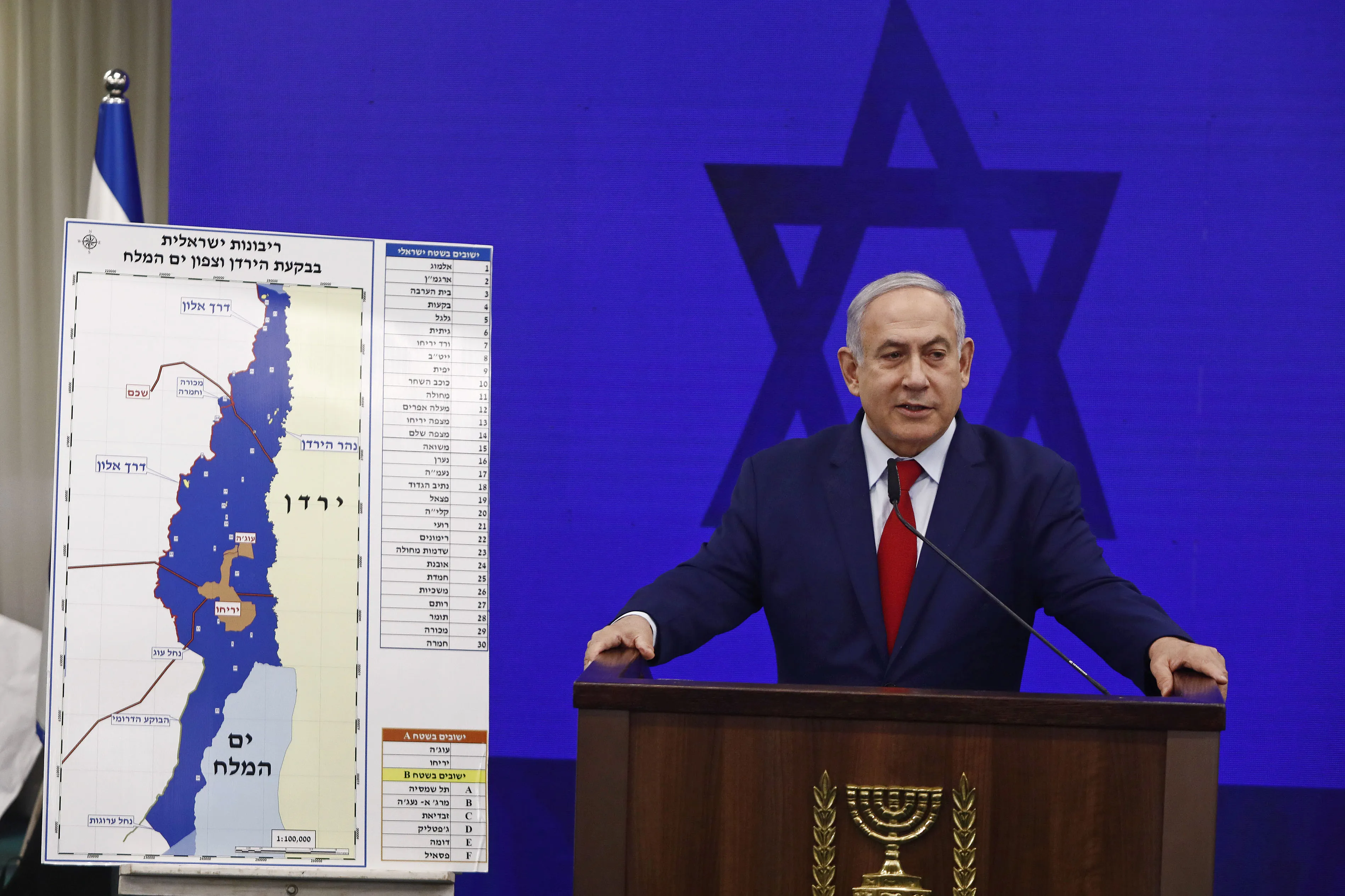 Benjamin Netanyahu speaks beside a map of the Jordan Valley and West Bank settlements,&nbsp;in Tel Aviv, on Sept. 10.