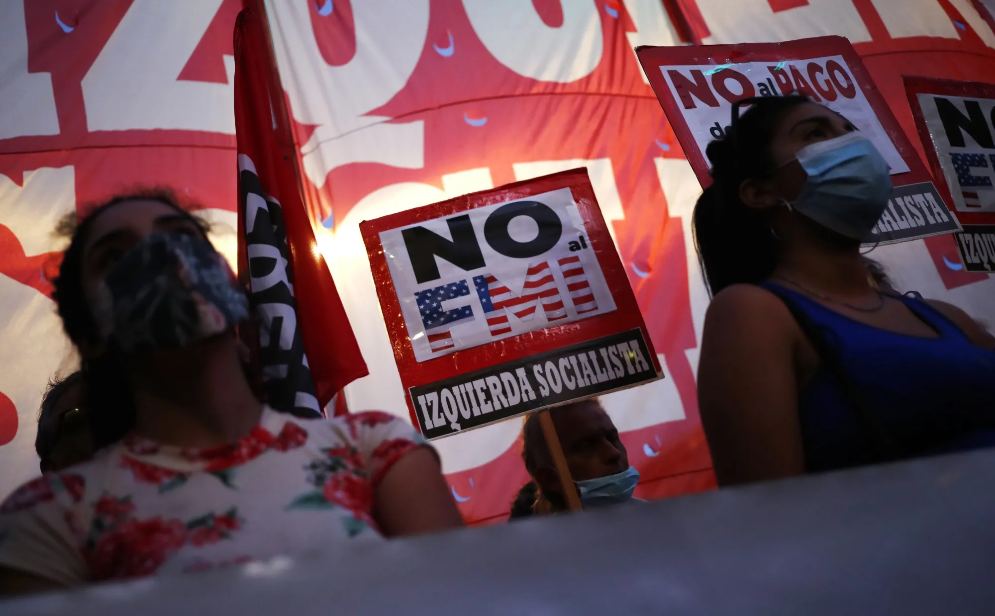 Demonstrators hold signs during a protest against the International Monetary Fund (IMF) agreement as lawmakers vote on the bill outside the National Congress building in Buenos Aires, Argentina, on&nbsp;March 17.