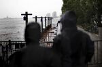 People look at a damaged boardwalk in the Battery Park neighborhood of Manhattan.
