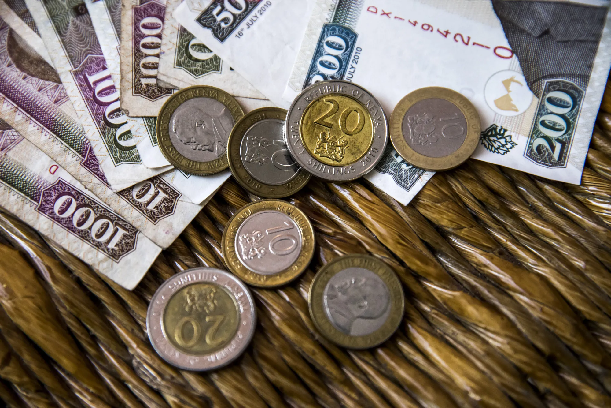Kenyan shilling banknotes and coins sit arranged at a market stall in Mombasa, Kenya, on Thursday, Nov. 23, 2017. The country’s Treasury has already cut this year’s growth target to 5 percent from 5.9 percent as the protracted election furor damped investment and a drought curbed farm output.