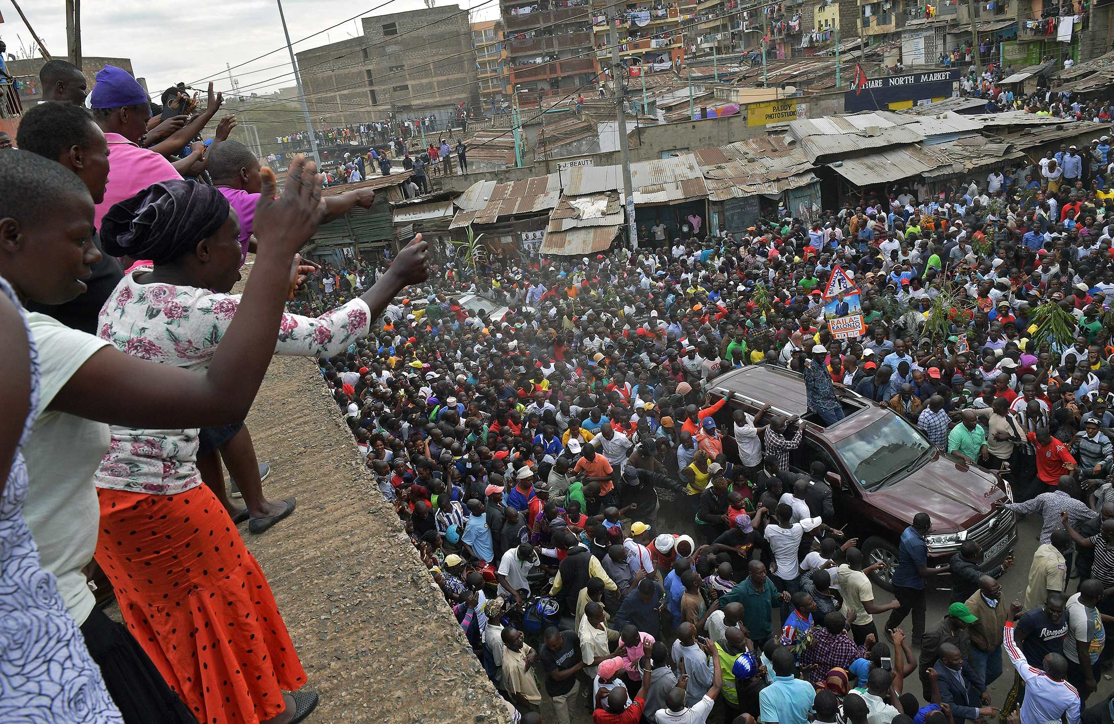 Kenya's opposition leader Raila Odinga leaves from the Mathare district of Nairobi on Aug. 13, after speaking to the family of a young girl killed in election-related violence.
