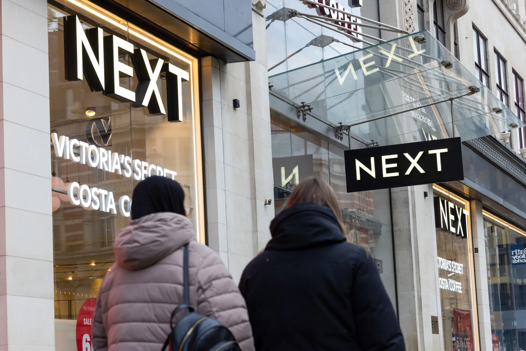 Next Plc Lifts Profit Forecast Again on Strong Holiday Sales