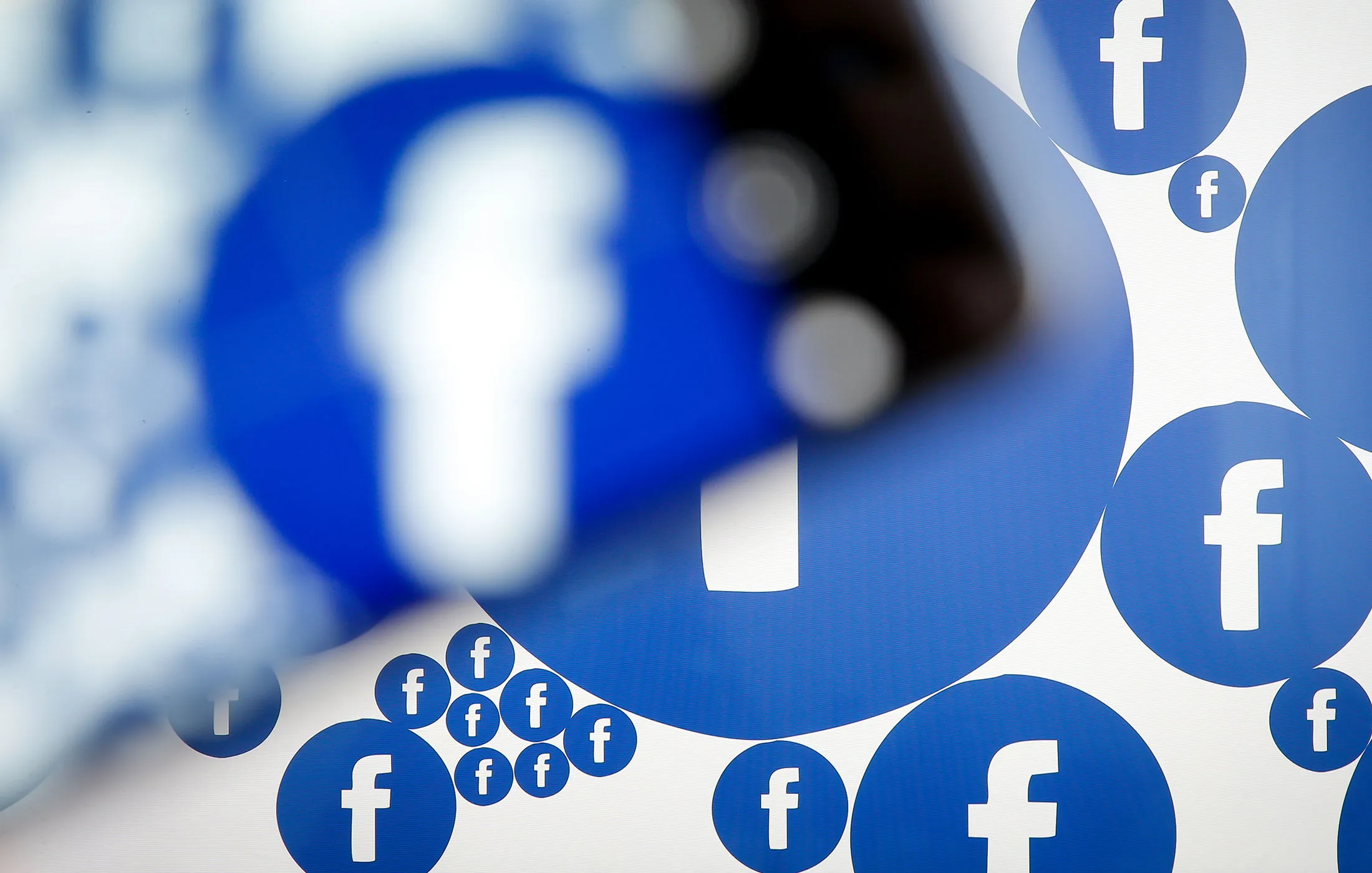 A Facebook logo is seen on various electronic devices on 28 March, 2017.
