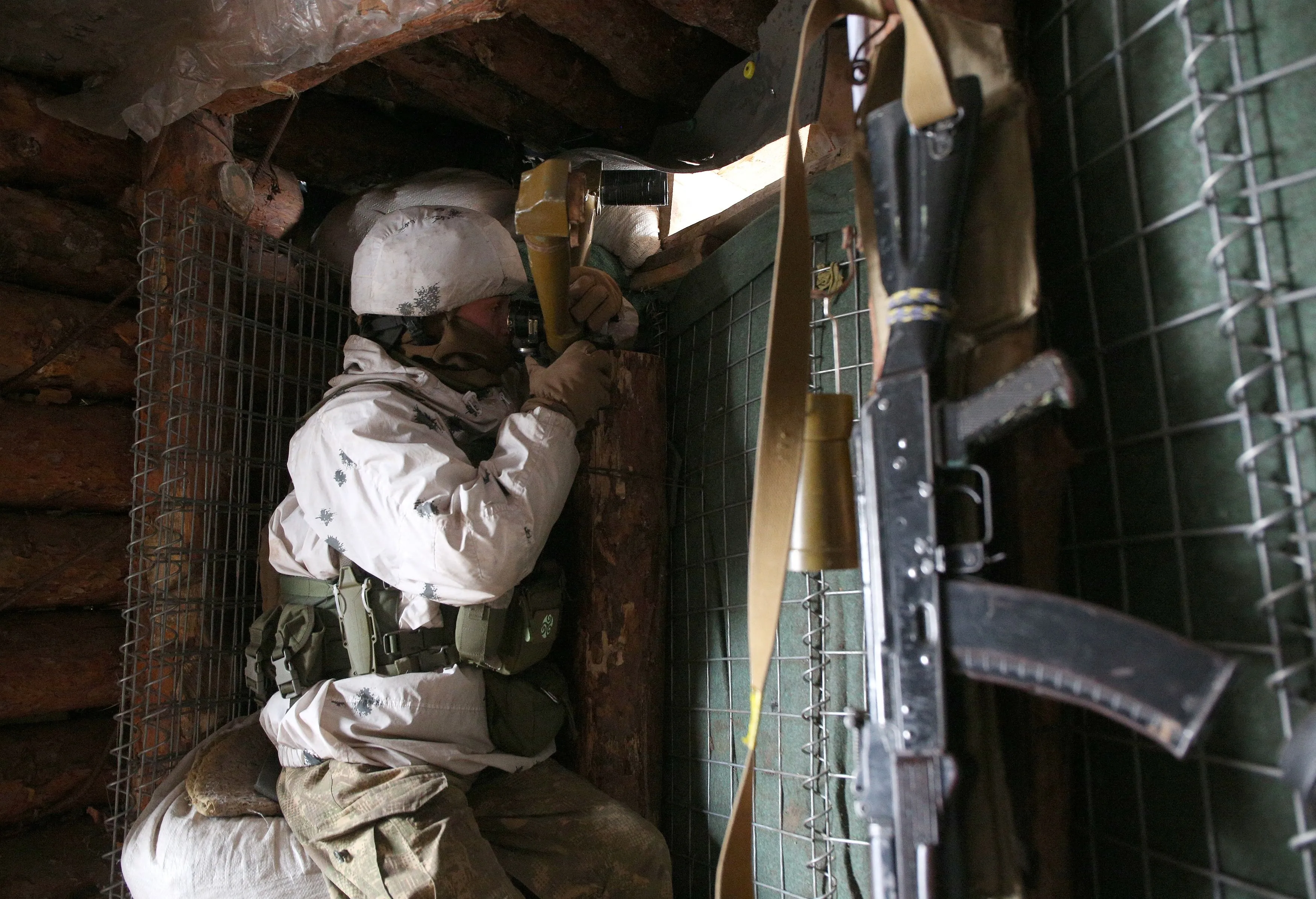A Ukrainian soldier looks out from a trench on the frontline, near Gorlivka, Ukraine, on Jan. 23.