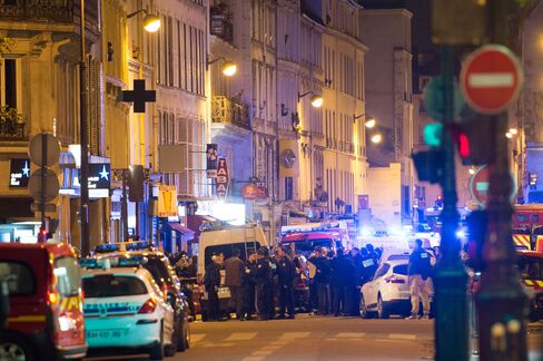 Officials investigate the scene outside the Bataclan concert hall