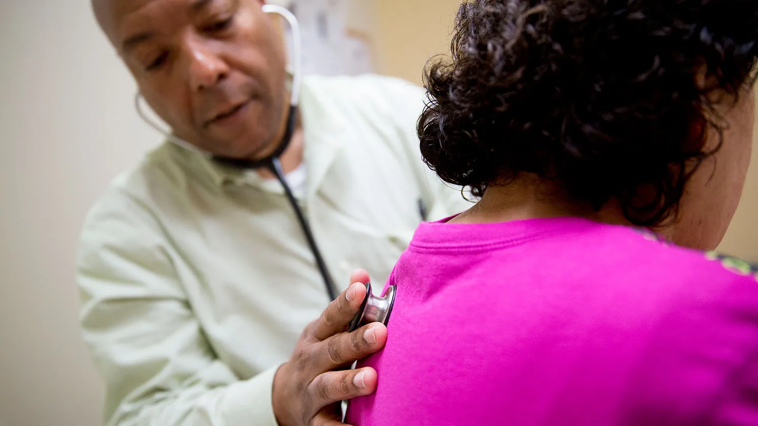 Family practice provider Rodell Cruise uses a stethoscope to examine a patient in an exam room at a Community Clinic Inc. health center in Silver Spring, Maryland, U.S., on Wednesday, April 8, 2015.
