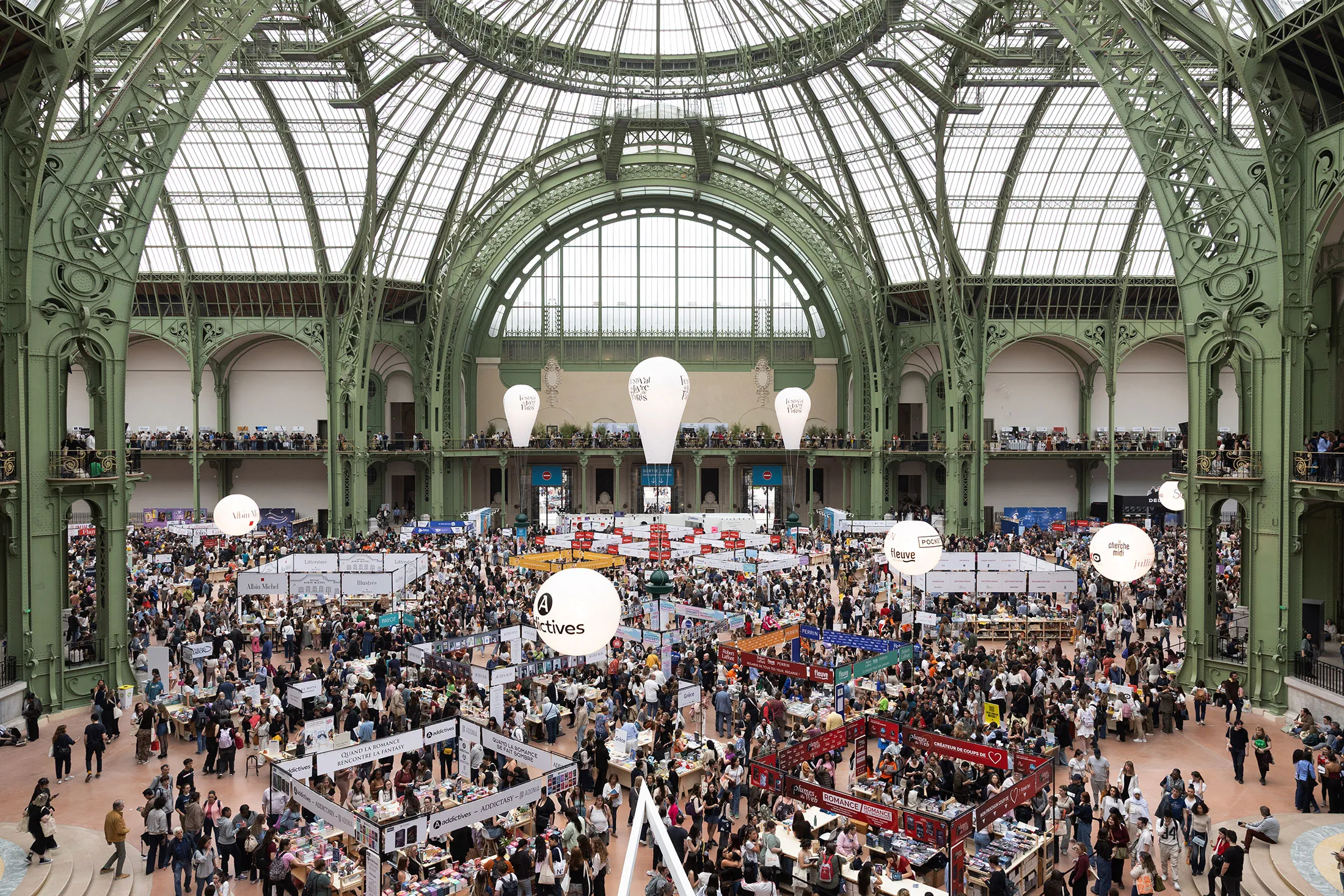 Visitors attend the 2025 Paris book fair at the Grand Palais.