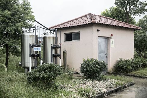 Two large water filtration tanks provide clean drinking water to the pigs at Shen's farm.