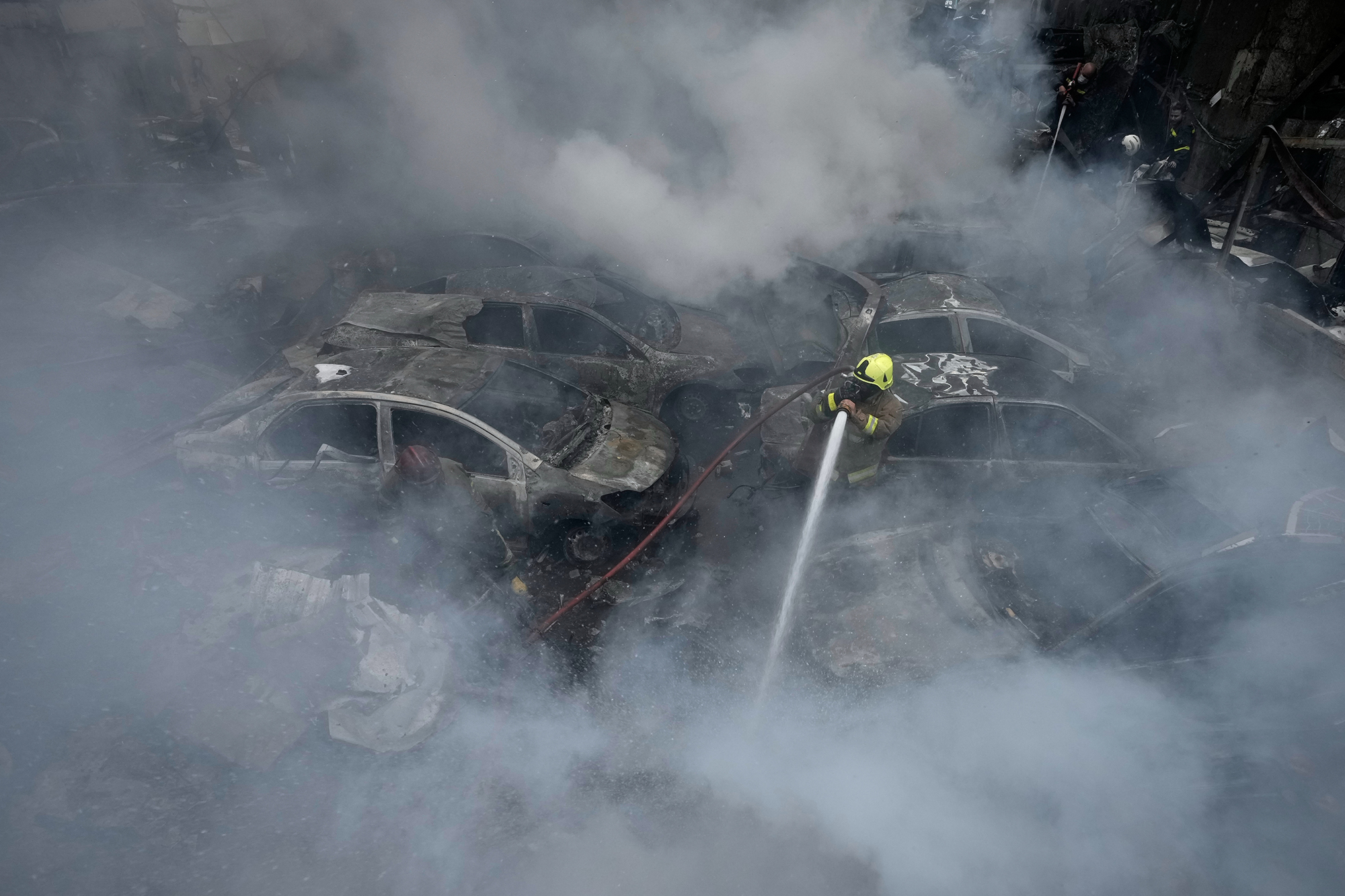 A firefighter sprays debris at the site of an airstrike&nbsp;in Beirut on April 8.