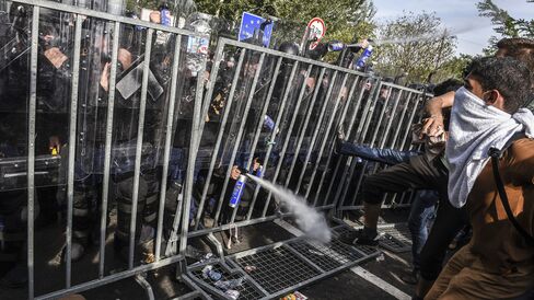 Hungarian police use pepper spray to push back refugees at the border with Serbia on Sept. 16.