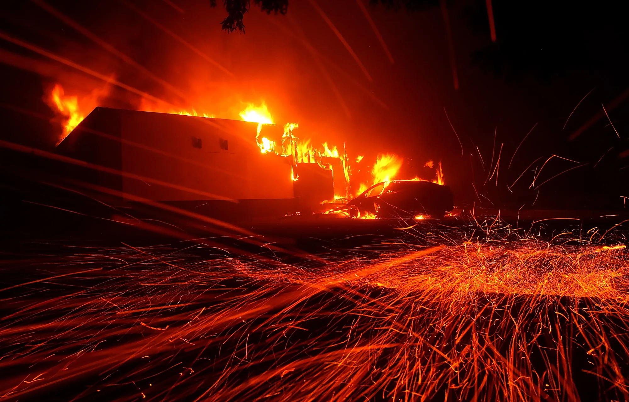 Embers blow in the wind as the Camp Fire burns a KFC restaurant on November 8, 2018 in Paradise, California.