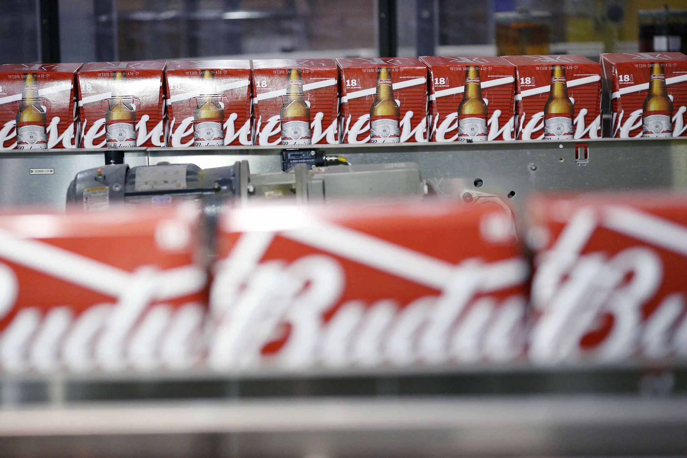 Cases of beer bottles move along a conveyor belt at the Anheuser-Busch InBev NV Budweiser bottling facility in St. Louis, Missouri, U.S., on Tuesday, Oct. 24, 2017.
