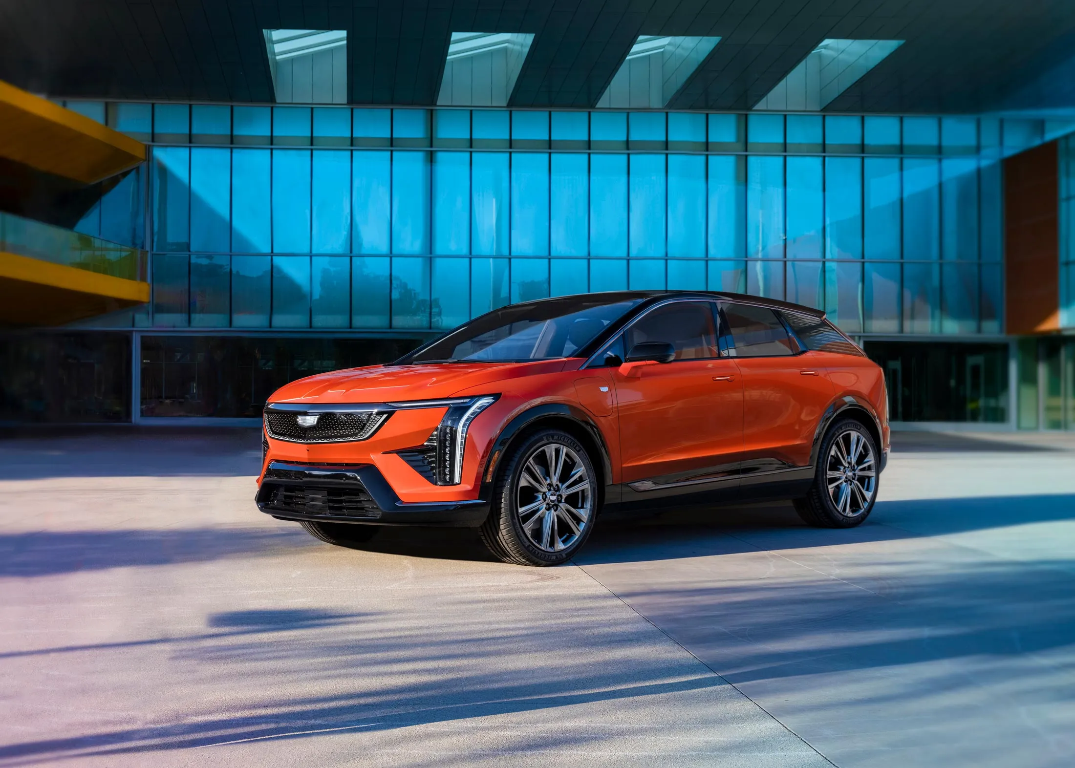 The 2025 Cadillac Optiq, shown here&nbsp;in monarch orange, is a new all-electric compact luxury SUV.