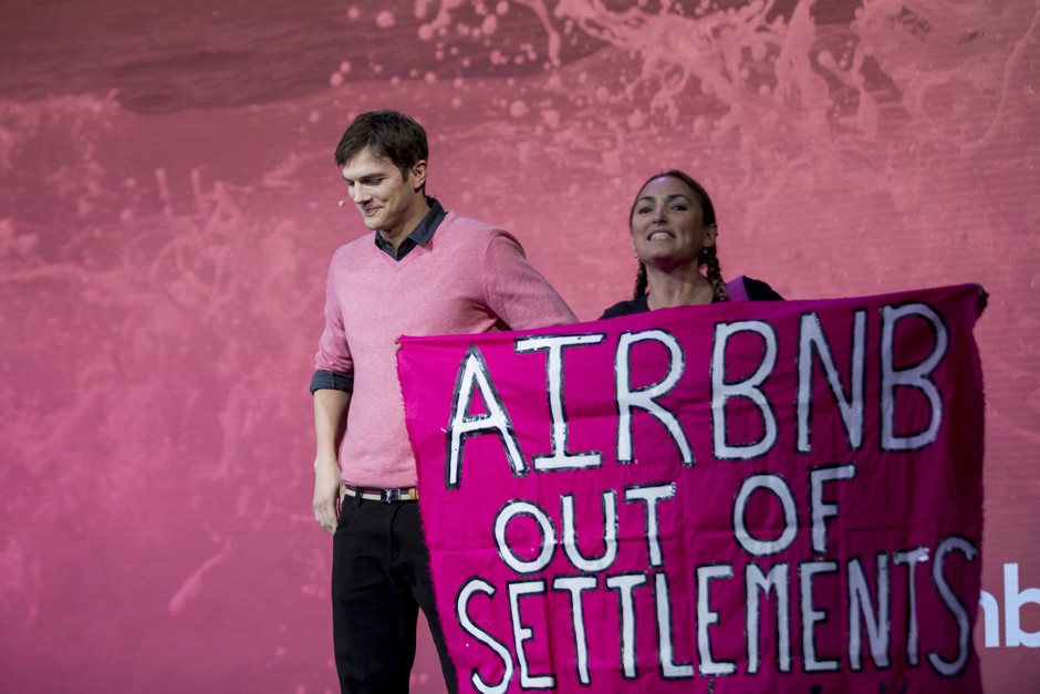 Ashton Kutcher is interrupted by an Airbnb protester at a panel in Los Angeles. 