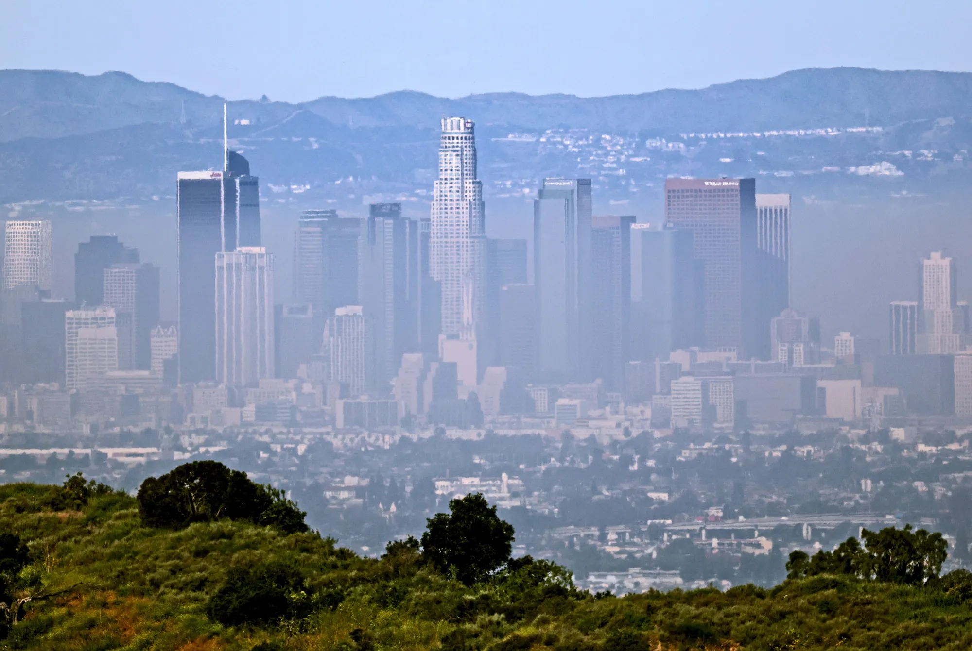 With temperatures rising, smog hangs low around downtown Los Angeles on March 16.
